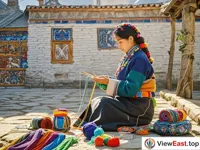 A Tibetan woman is sitting in the yard, concentrating on weaving and embroidering. There are colorful balls of thread and embroidered products beside her.
