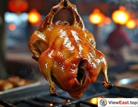A roast duck freshly removed from the hanging oven, steaming hot with a golden-brown skin that glistens with oil. The background features a traditional roasting oven and a busy duck master at work.