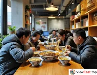  In a busy office, colleagues gather around to share freshly delivered Lanzhou beef noodles, with the aroma filling the air and bringing a moment of relaxation to the tense work atmosphere.