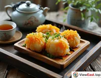 Hairy Crab Meatballs are placed on an antique wooden tray, next to a pot of fragrant tea, creating a leisurely afternoon tea time.