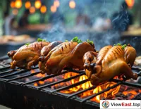 At an outdoor barbecue party, Hainan Wenchang Chicken is grilling on the barbecue rack, making sizzling sounds, with oil dripping and aroma wafting.