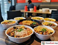 In the office, colleagues gather around a table, sharing takeout Liuzhou Luosi Rice Noodles, with the tangy and spicy scent filling the air.