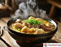 In a traditional wooden house in Yunnan, there is a steaming Yunnan steam pot chicken placed on a simple wooden table. The unique shape of the steam pot perfectly preserves the deliciousness of chicken under the action of steam. The golden soup and tender chicken, matched with green scallions, make people's mouths water.