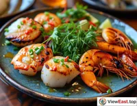 A plate of freshly grilled seafood is served, including scallops, shrimp, and fish, with a bright color that makes one's mouth water.