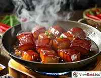 In a food blogger's video, the process of making Braised Pork Belly is detailed, with the meat cubes rolling in the pot and emitting a rich fragrance.