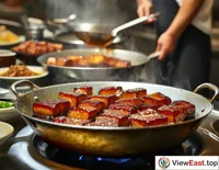 In a kitchen, a chef carefully cooks Braised Pork Belly, with the meat cubes slowly turning glossy in soy sauce and sugar.