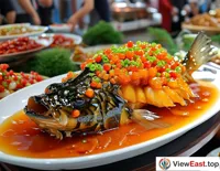 At a food festival booth, West Lake vinegar fish attracts attention with its bright color and sweet and sour taste.