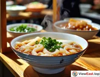 At a food festival booth, steaming bowls of Cross-Bridge Rice Noodles are served to diners, tempting them to taste immediately.