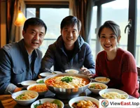 At a family gathering, family members sit together, enjoying homemade Cross-Bridge Rice Noodles, creating a warm atmosphere.