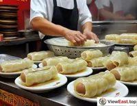 In a time-honored Cheong fun shop in Guangdong, a master deftly crafts plate after plate, each bite a genuine Cantonese flavor.
