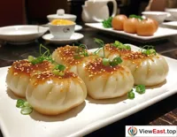 In an upscale Shanghai hotel, soup dumplings are presented as a specialty snack, with exquisite plating and a crispy texture that wins praise from diners.