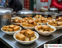 Outside a Hunan train station, a small cart selling stinky tofu offers a tasty consolation to travelers on the go.