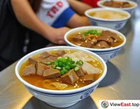 In a Jiangsu university cafeteria, students line up for a bowl of duck blood and vermicelli soup, a popular campus favorite.