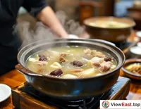 In a Jiangxi restaurant, waiters serve piping hot clay pot soups, with a clear broth revealing glimpses of medicinal herbs and meat chunks.