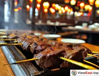 In a Xinjiang restaurant, skewers of mutton on willow branches are served, exuding an enticing color.