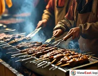 At Xinjiang's night market, by the smoky grill, chefs are turning mutton skewers with sizzling oil drops, filling the air with fragrance.