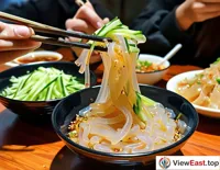 In a Gansu snack shop, a customer picks up transparent liangpi with chopsticks, matched with cucumber shreds and gluten, smooth in texture.