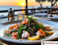 A quinoa salad topped with fresh seafood and lemon slices at a seaside open-air restaurant, with a sea breeze adding a touch of coolness to summer.