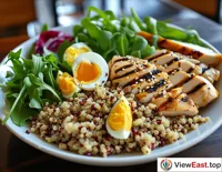 A quinoa salad with boiled eggs and grilled chicken breast in a gym lounge, providing ample protein post-workout.