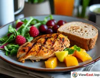 Roasted chicken breast with whole wheat bread and fresh fruit during office lunchtime, bringing nutrition and vitality to a busy workday.