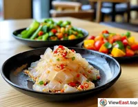 Jellyfish salad with a plate of steamed vegetables at a gym light food bar, providing a low-calorie healthy meal post-workout.