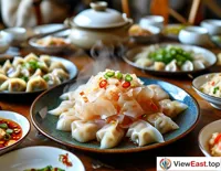 A plate of jellyfish salad on a family gathering table, surrounded by steaming hot dumplings.