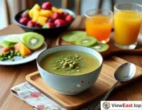 A bowl of mung bean soup with a fruit platter during a leisurely weekend brunch, providing the perfect start to a relaxing morning.