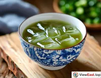 A bowl of chilled mung bean soup with ice cubes on a hot summer afternoon, bringing a breath of coolness to the heat.