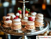 Delicate French macarons are served on silver trays at an upscale cocktail party for guests to enjoy.