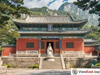 Bixia Temple on Mount Tai, a serene Taoist sanctuary with traditional red walls and green tiles.