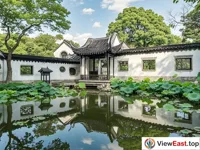 The mirror-like lake reflecting traditional buildings in the Humble Administrator's Garden in Suzhou's gardens.