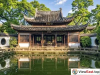 The Precious Book Building of Tianyi Pavilion in Ningbo, where ancient trees and green shades create a serene reflection.